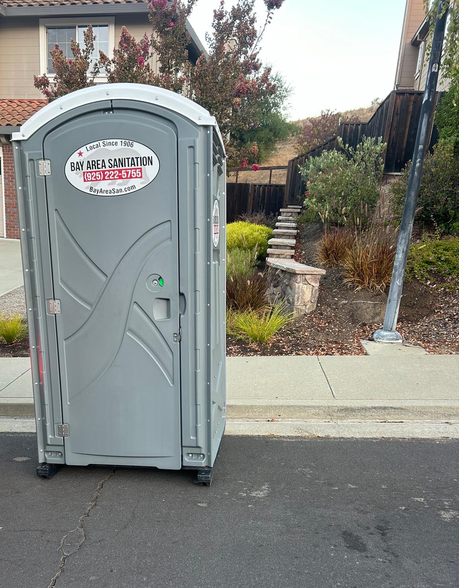 Bay Area Sanitation porta potty at a residential curb, available in Morgan Hill