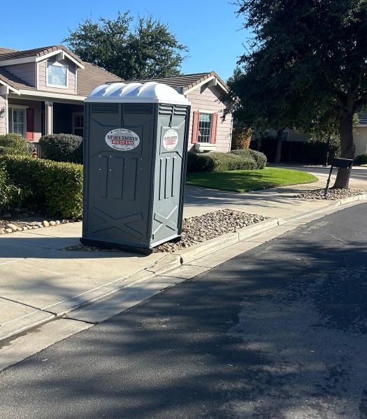 Porta potty at the curb in front of a single-family home, available in Suisun City